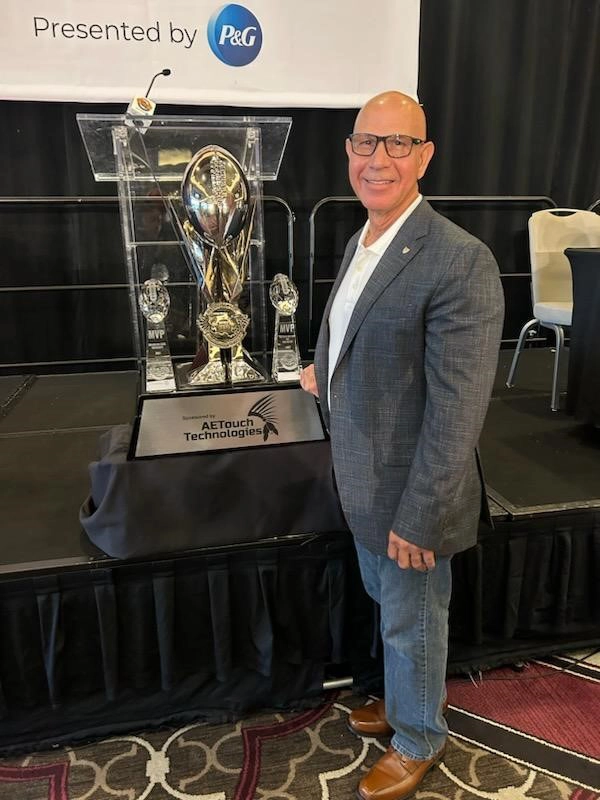 Adam receiving award